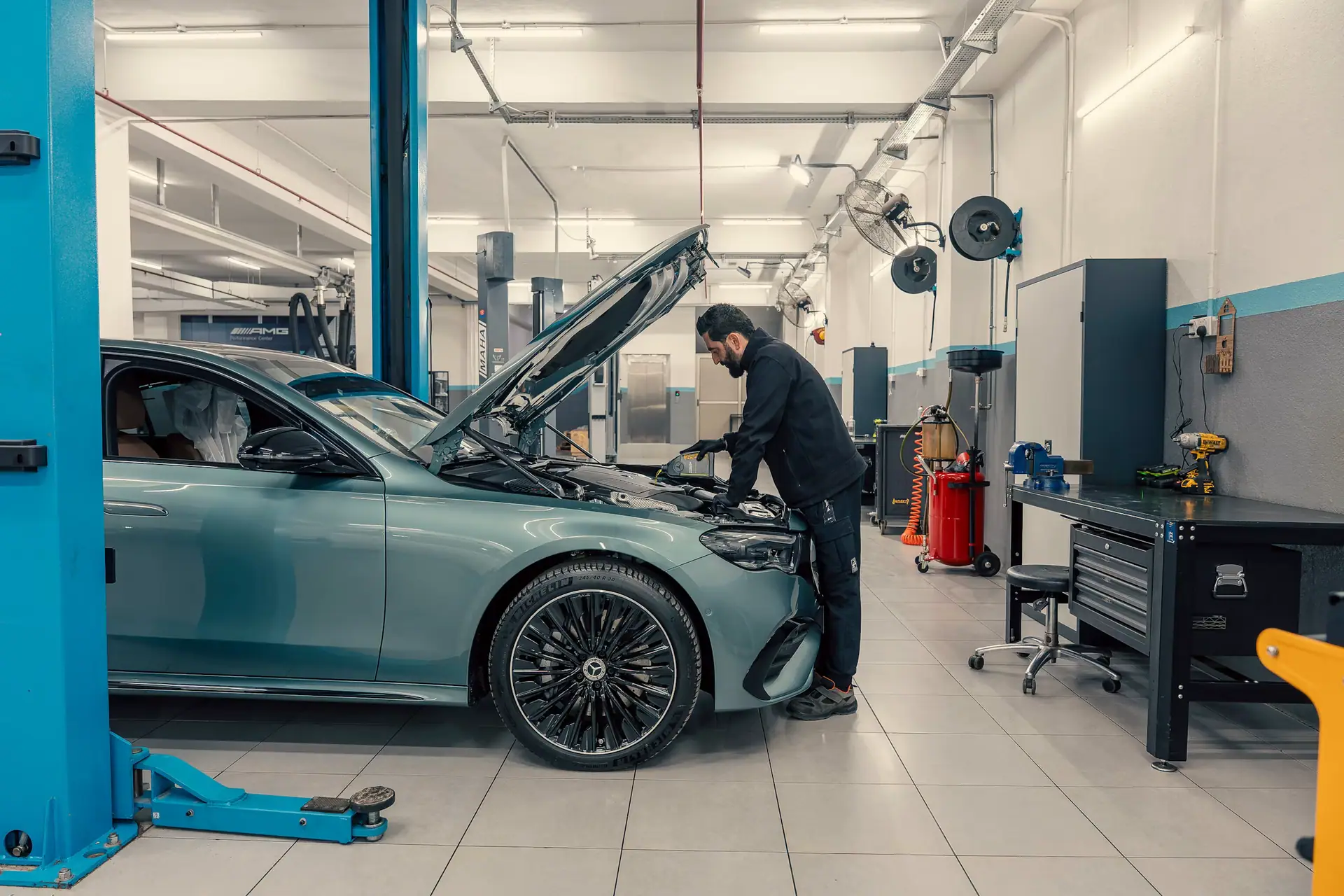 Mechanic working on a car in a modern workshop